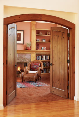 Reused stone set against alder bookshelves and a terra-cotta floor changed the cold surfaces of the study into a warm and inviting space.
